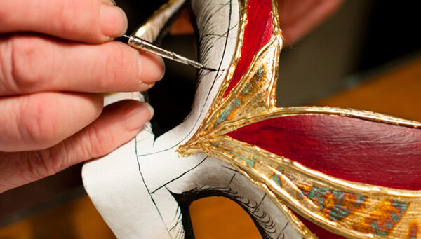Artisan colouring a venetian carnival mask